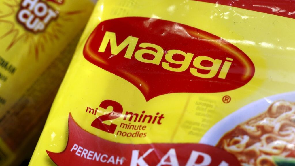 Food giant Nestle lowered its full-year outlook on Friday after setbacks from a Maggi noodle recall in India and a rebate adjustment in its skin health division in the third quarter.