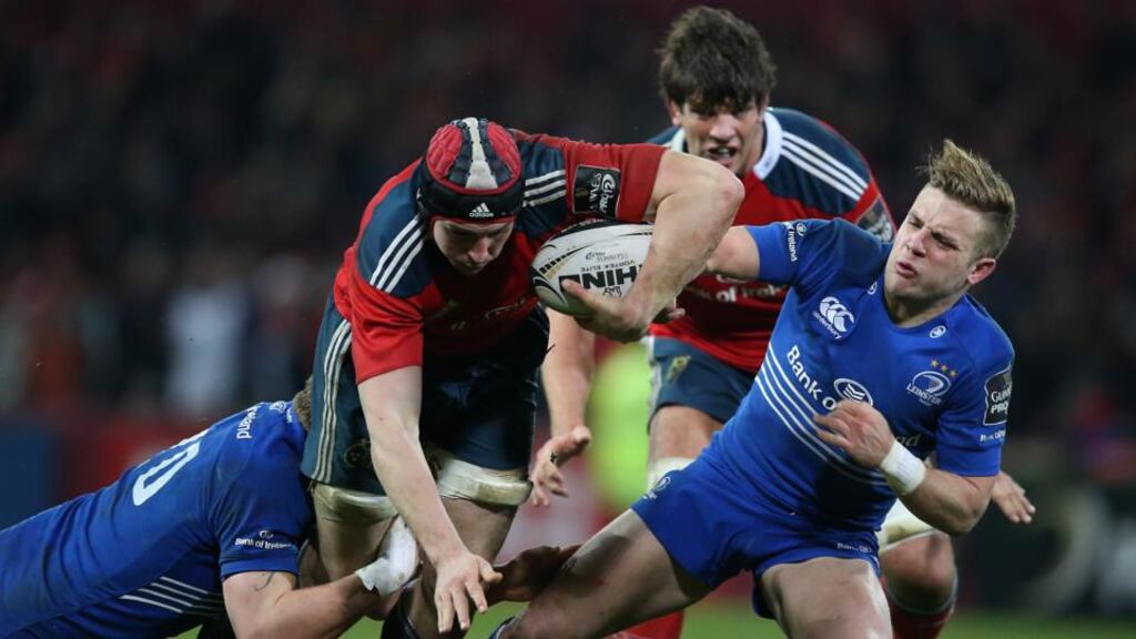 Munster’s Tommy O’Donnell brushes off Leinster’s Jordi Murphy and Ian Madigan during the provinces’ Guinness PRO12 clash on St Stephen’s Day in Thomond Park. Photograph: Billy Stickland/Inpho