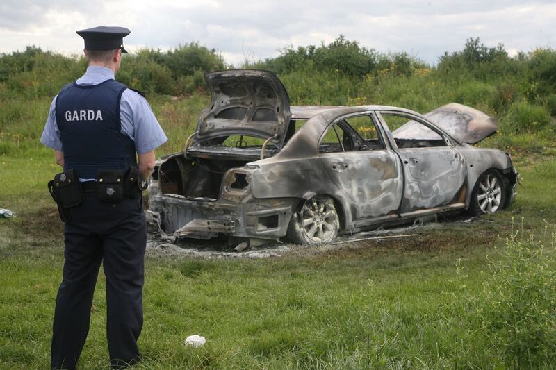 DESTROYING EVIDENCE: This saloon car was found burned out near the scene of an earlier fatal shooting on Kilbarron Road in Coolock on Tuesday. Photograph: Padraig O'Reilly
