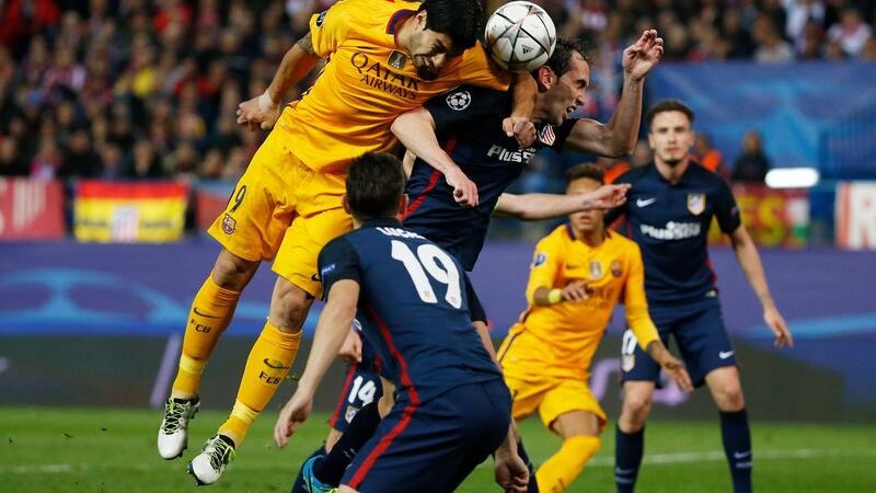 Barcelona’s Luis Suarez elbows Atletico’s Diego Godin. Photo: Reuters