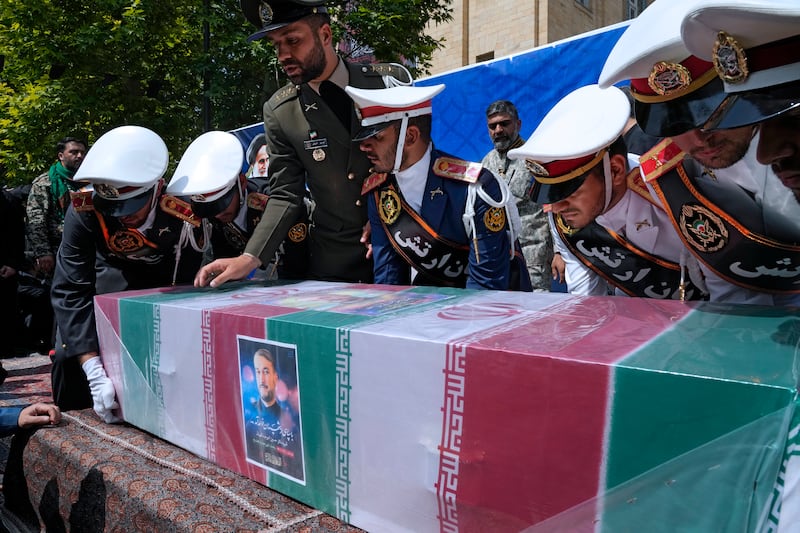 Army members place the coffin of foreign minister Hossein Amirabdollahian on a stage during proceeding. Photograph: Vahid Salemi/AP)