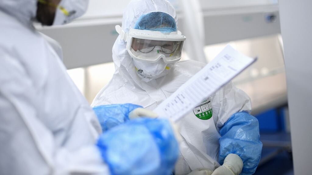 Laboratory technicians work on samples from people to be tested for the new coronavirus in Wuhan. Photograph: STR/AFP via Getty Images
