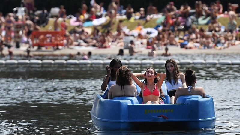 People enjoy the hot weather at Hyde Park in London. Photogaph: Andy Rain/EPA
