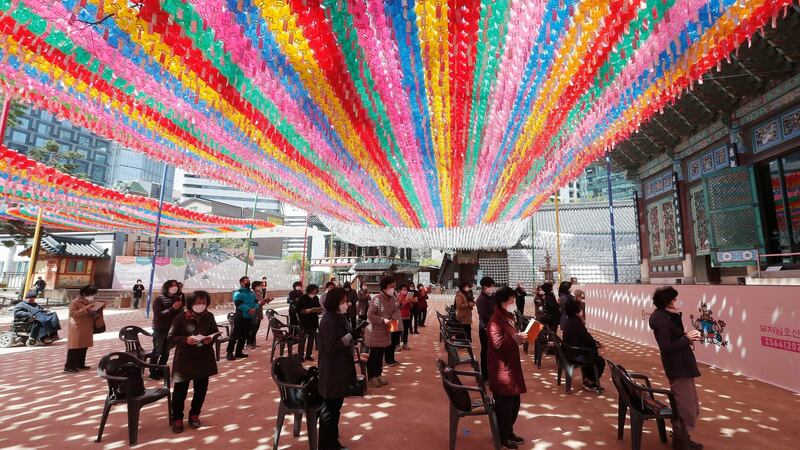 Buddhists wearing face masks to help protect against the spread of the new coronavirus maintain social distancing during a service at the Chogyesa temple in South Korea on Friday. Photograph: AP Photo/Ahn Young-joon