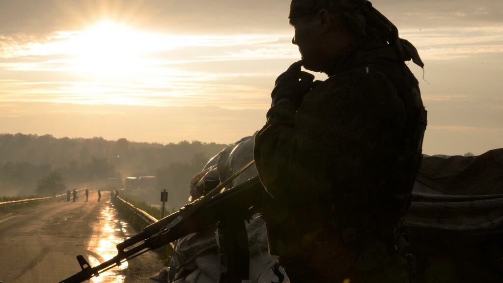 Pro-Russian militants guard a street near the village of Karlivka, near Donetsk in Ukraine. Photograph: EPA