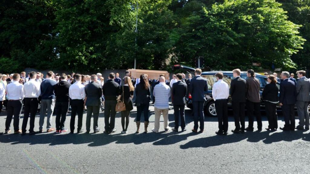 Family and friends carry the remains of Eoghan Culligan , who died tragically in a balcony collapse in Berkeley, California in through students from St Marys College guard of honour before the funeral Mass at the Church of the Annunciation in Rathfarnham. Photograph: Alan Betson/The Irish Times
