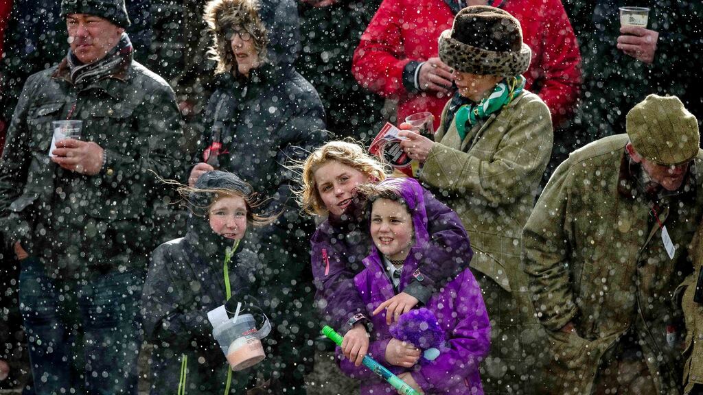 Racegoers contending with hail on the third day of the Punchestown festival. Photograph: INPHO/Morgan Treacy