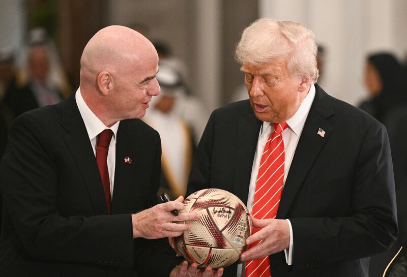 Fifa president Gianni Infantino gives US president Donald Trump a football  to autograph during a signing ceremony after a state dinner with Qatar's Emir Sheikh Tamim bin Hamad al-Thani in Doha on May 14th. Photograph: Brendan Smialowski/AFP via Getty Images