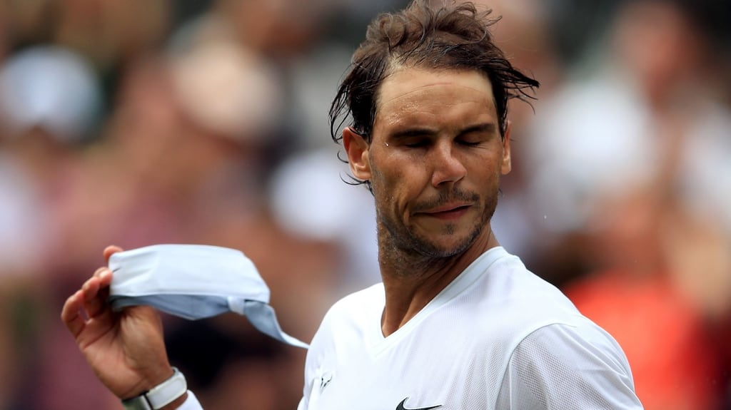 Rafael Nadal removes his head band after his match on day seven. Photograph: PA