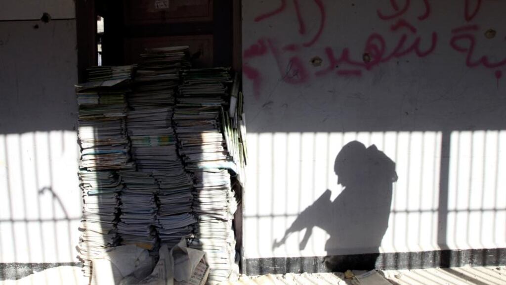 The shadow of a Free Syrian Army fighter is cast on a wall of a school in Sheikh Maksoud area in Aleppo. Photograph: Muzaffar Salman/Reuters