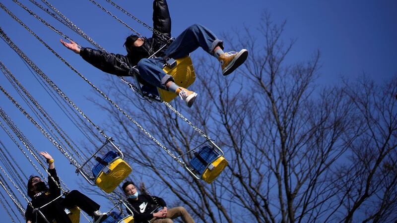 People wearing protective face masks are seen at the Happy Valley amusement park on its first day of opening following the outbreak of coronavirus disease  in Shanghai on Friday. Photograph: Aly Song/Reuters