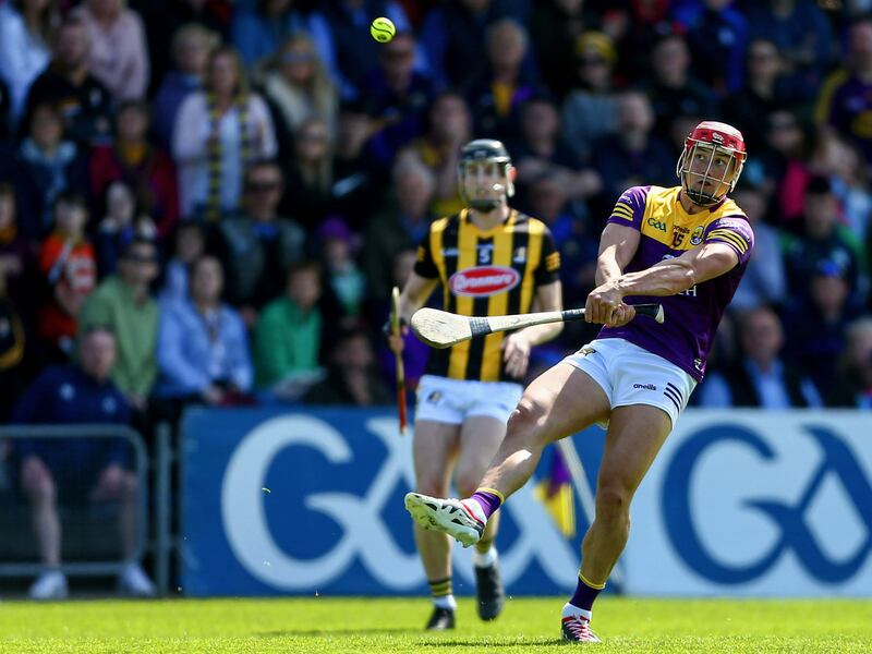Wexford’s Lee Chin scores fires over a point against Kilkenny. Photograph: Ken Sutton/Inpho