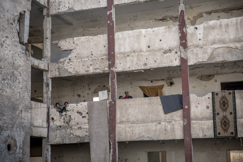 A single father and some of his nine children, who shelter in a destroyed school in Homs. Photograph: Sally Hayden