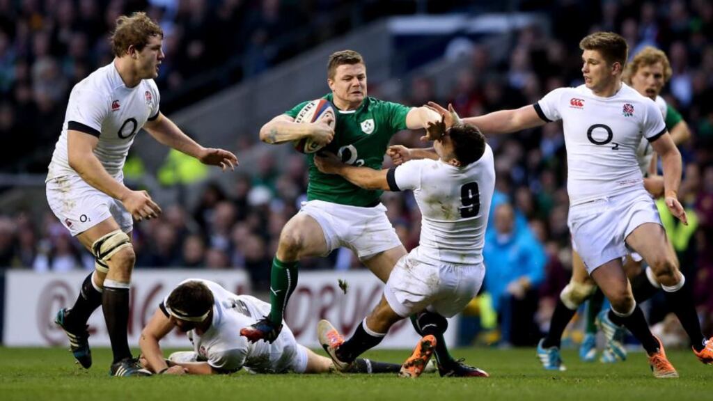 Ireland’s Brian O’Driscoll hands off England’s Danny Care during Saturday’s match at Twickenham. Photograph: James Crombie/Inpho