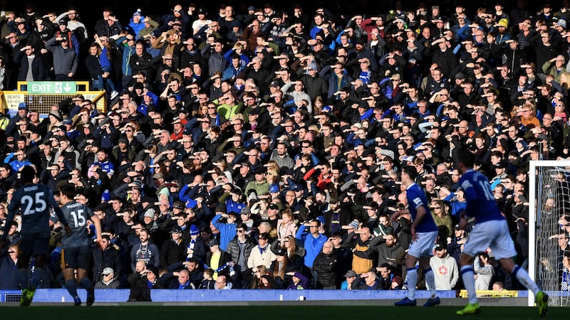 Fan at Goodison Park shield their eyes from the sun during Everton’s defeat to Leicester City. Photograph: Paul Ellis/AFP/Getty