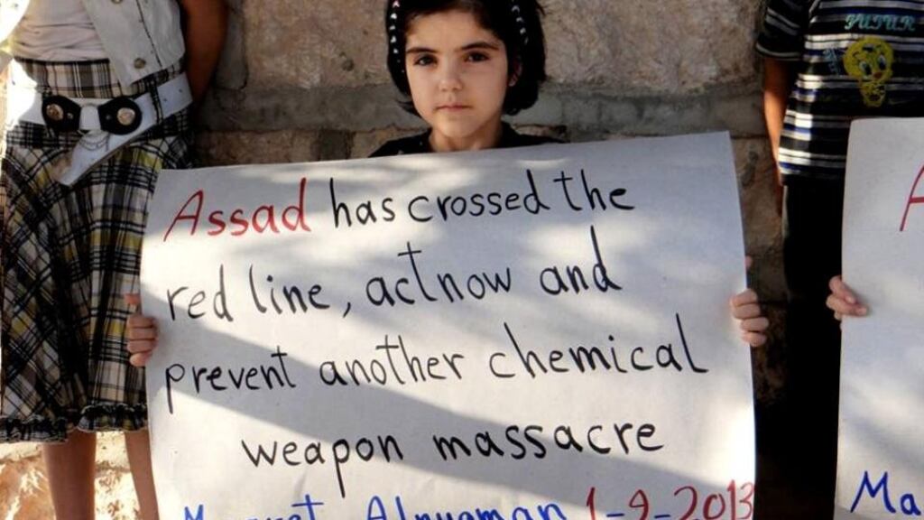 A Syrian girl holds a sign during a demonstration on Sunday in Maaret al-Numan, Idlib province, northern Syria. Photograph: Edlib News Network ENN/AP
