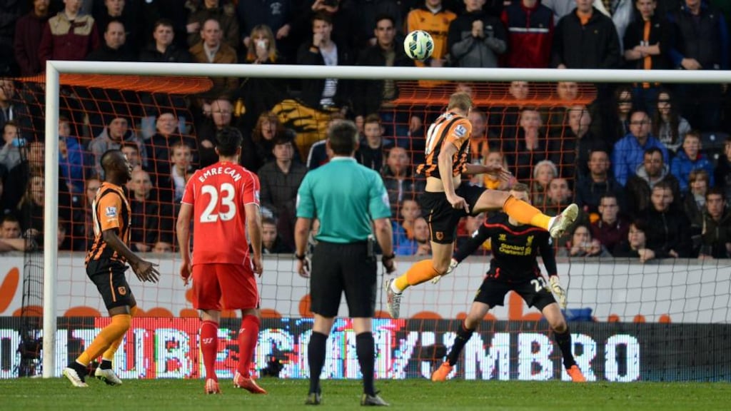 Hull City’s Michael Dawson heads home a goal in the Premier League game against Liverpool at the KC Stadium, Photo: Martin Rickett/PA Wire
