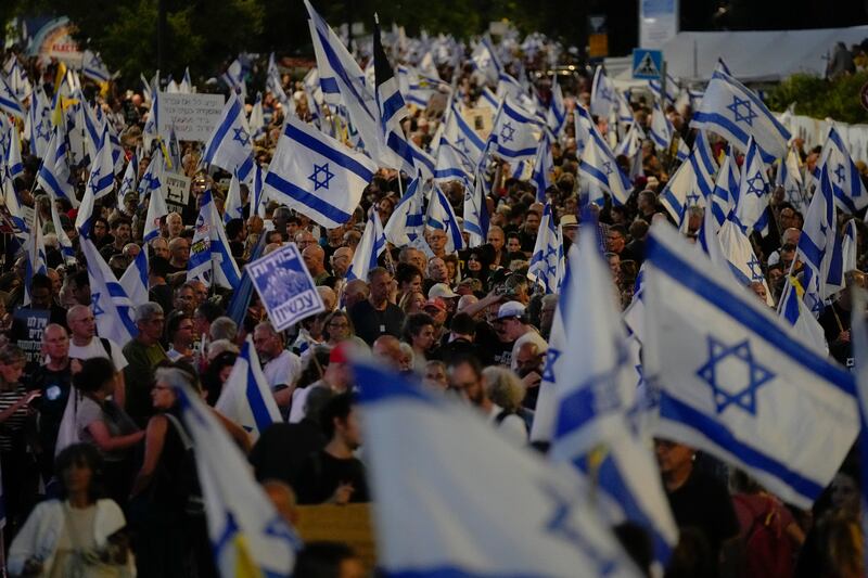 People wave Israeli flags during a protest against Israeli prime minister Binyamin Netanyahu’s government. Photograph: Ohad Zwigenberg/AP