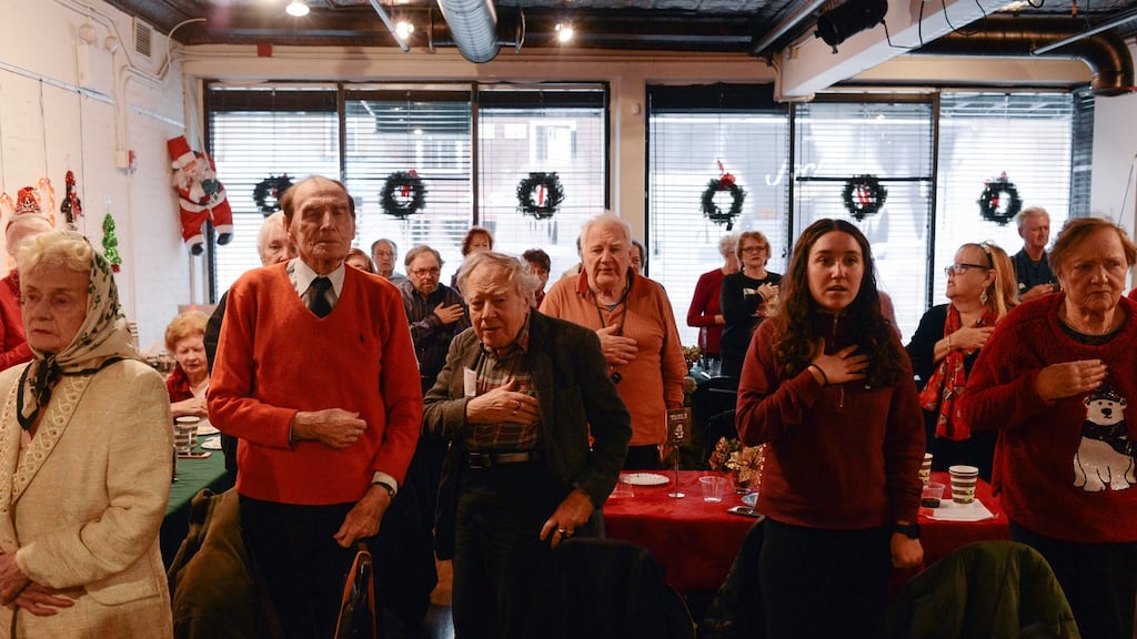 Visitors pledge the oath of allegiance at the New York Irish Center’s Christmas lunch. Photograph: Lauren Crothers