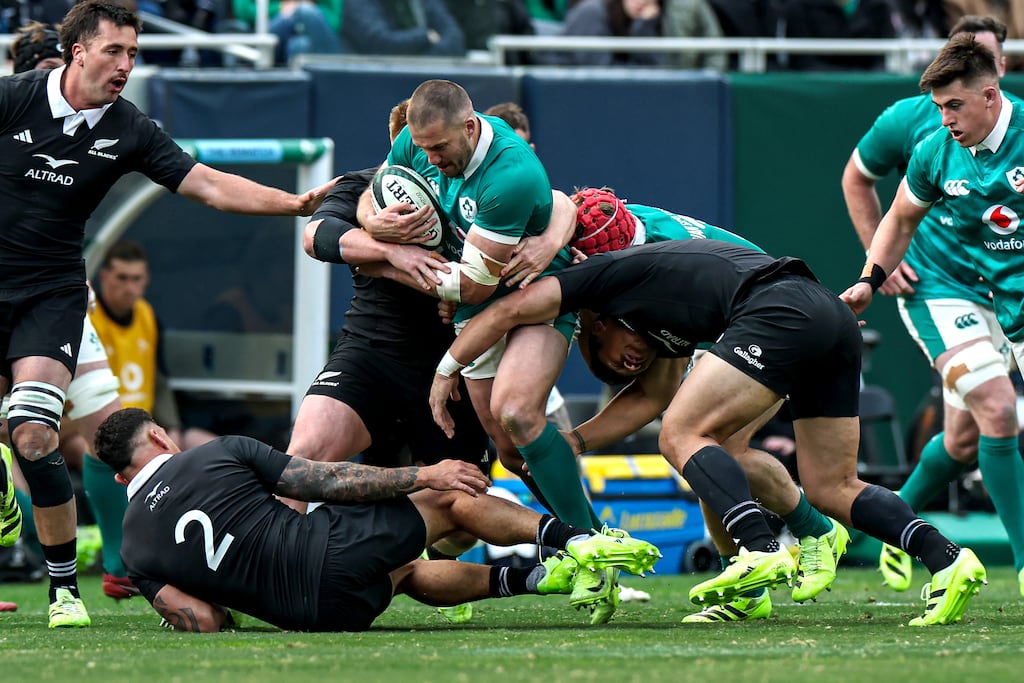 Ireland's Stuart McCloskey keeps possession of the ball despite the best efforts of New Zealand's Codie Taylor during last Saturday's Test at Soldier Field, Chicago. Photograph: Gary Carr/Inpho
