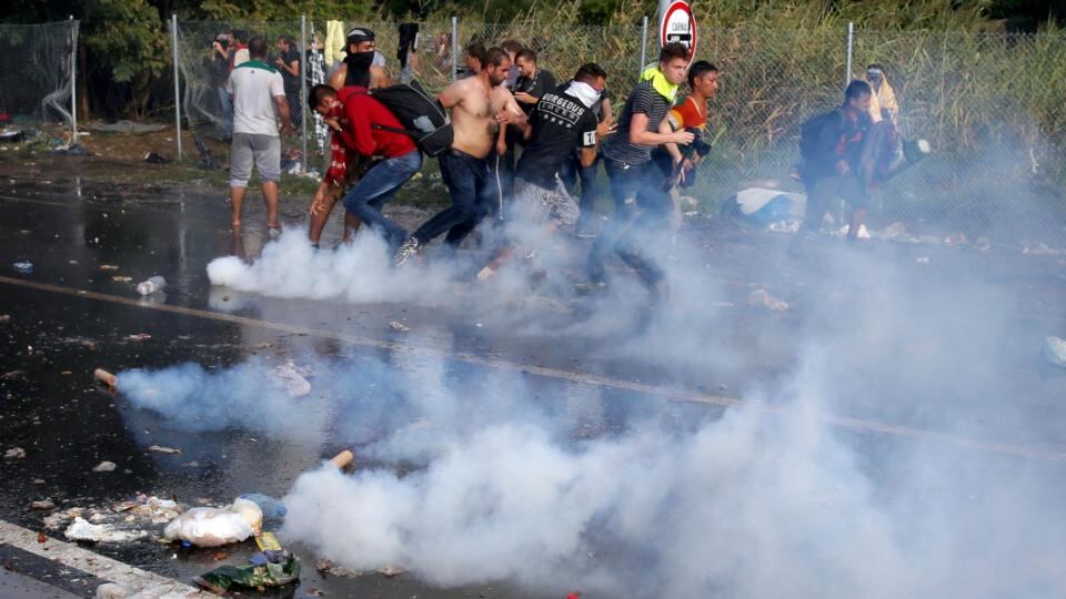 Migrant protest as Hungarian riot police fires tear gas and water cannon at the border crossing with Serbia in Roszke, Hungary, September 16th, 2015. Photograph: Marko Djurica/Reuters