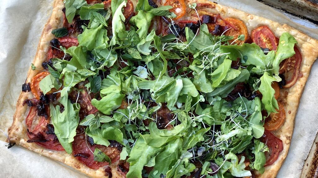 A crunchy BLT tart with ripe, end-of-the-summer tomatoes, crumbled candied bacon and a thicket of baby lettuces greening the top. Photograph: Melissa Clark/The New York Times