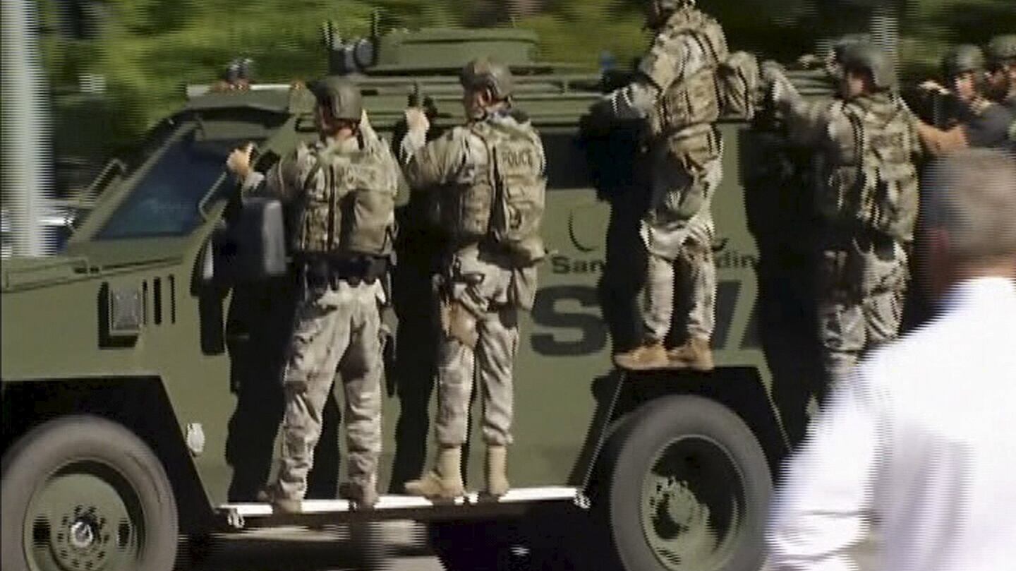Police Swat team units on an armoured vehicle arrive outside the Inland Regional Center in San Bernardino, California. Photograph: Handout via Reuters