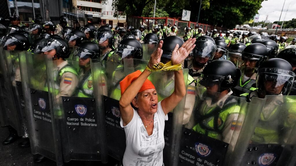 Oposition members shout slogans in front of the Venezuelan police during demonstrations in Caracas, Venezuela on Tuesday. Photograph: EPA/Miguel Gutierrez