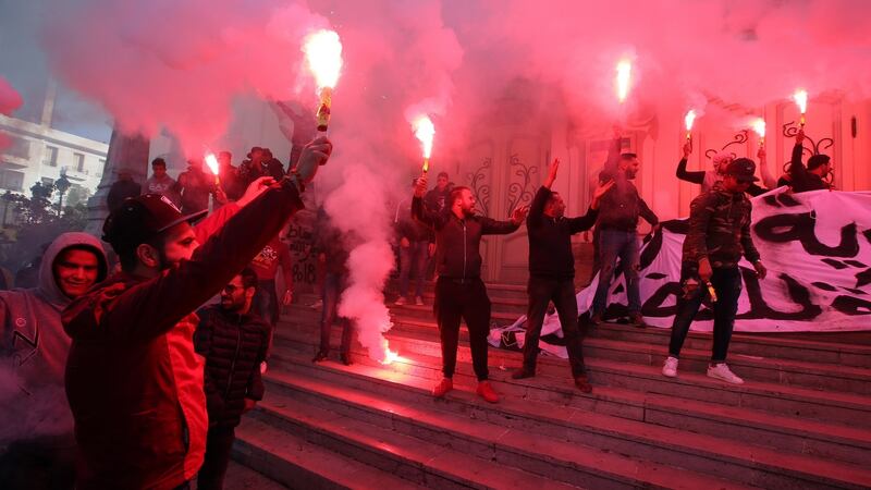 Tunisian protesters light flares and shout slogans during a celebration to mark the seventh anniversary of the uprising. Photograph: Mohamed Messara/EPA