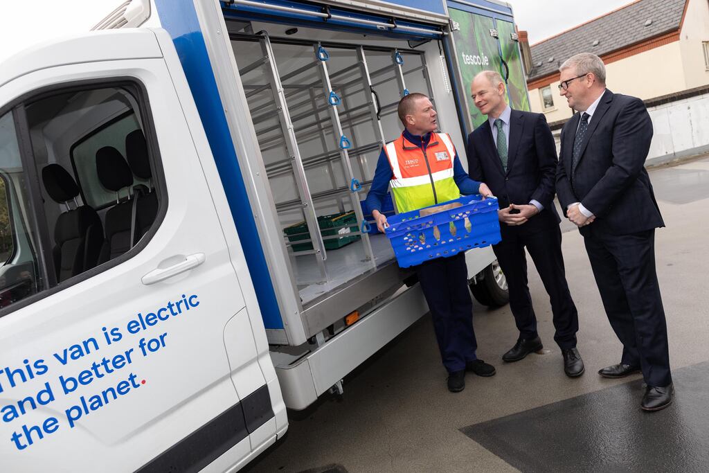 Tesco Ireland is introducing an electric vehicle for grocery deliveries, part of its efforts to become net zero in its own operations by 2035. Pictured are Ossian Smyth, Minister of State with responsibility for Public Procurement, eGovernment and Circular Economy, Tesco Ireland chief operating officer Geoff Byrne, and home delivery driver Phillip Mahon.