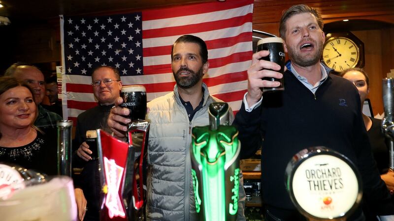 Donald Trump jnr (centre), and Eric Trump (right) behind the bar in Tubridy’s Bar in the village of Doonbeg, Co Clare. Photograph: Brian Lawless/PA Wire