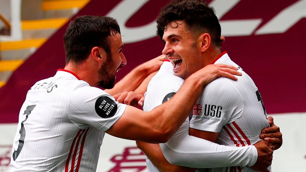 Enda Stevens celebrates with John Egan after he scored a late equaliser against Burnley. Photograph: Clive Brunskill/Getty/AFP