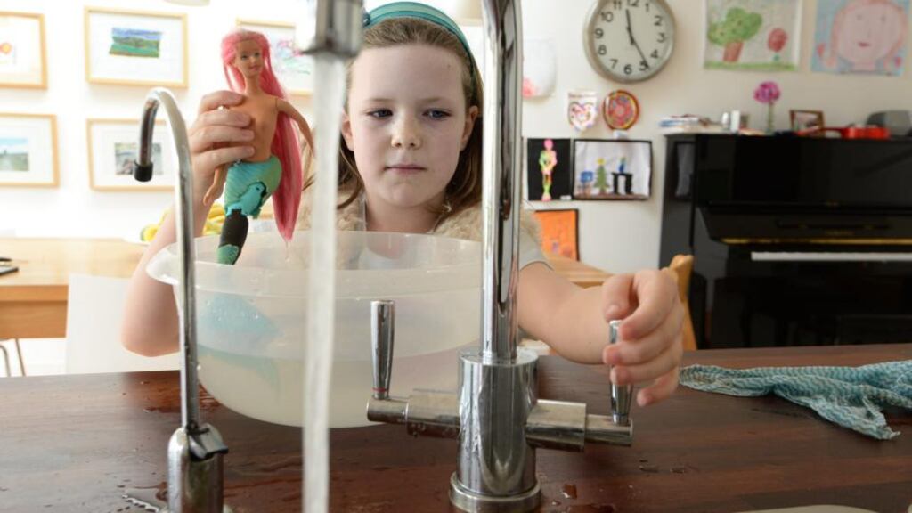 Bath time: Grace Robbins keeps an eye on how much water she is using to wash her mermaid. Photograph: Cyril Byrne