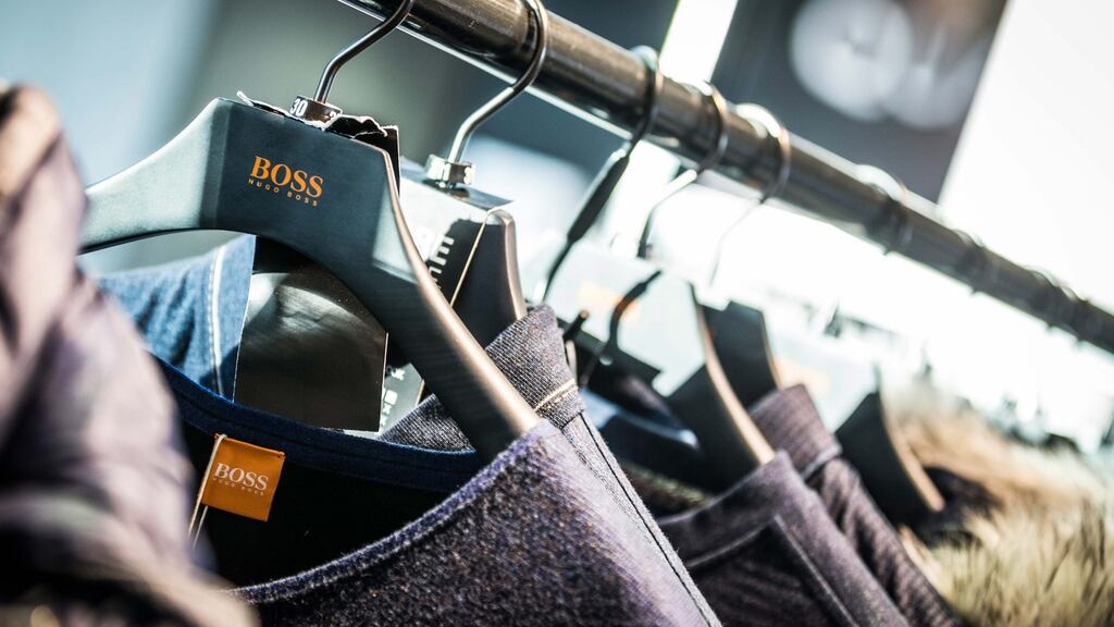 Hugo Boss shares slumped 9 per cent after the fashion house cut its 2015 sales and profit outlook.