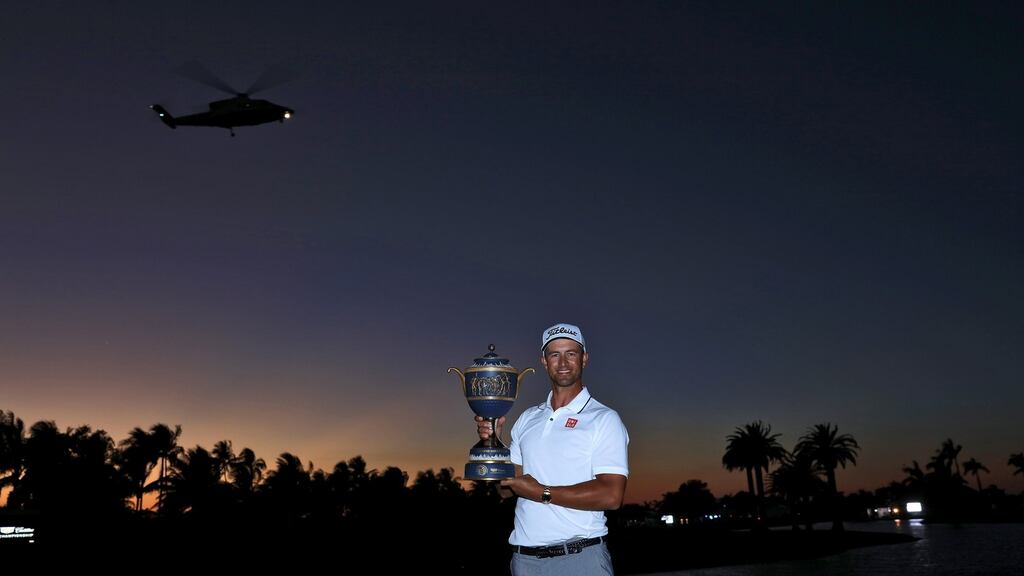 Adam Scott with the WGC-Cadillac Championship trophy, with Donald Trump’s helicopter taking off in the background. Photograph: Getty