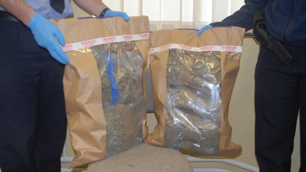 Gardaí holding bags of cannabis seized during an operation in Co Clare.