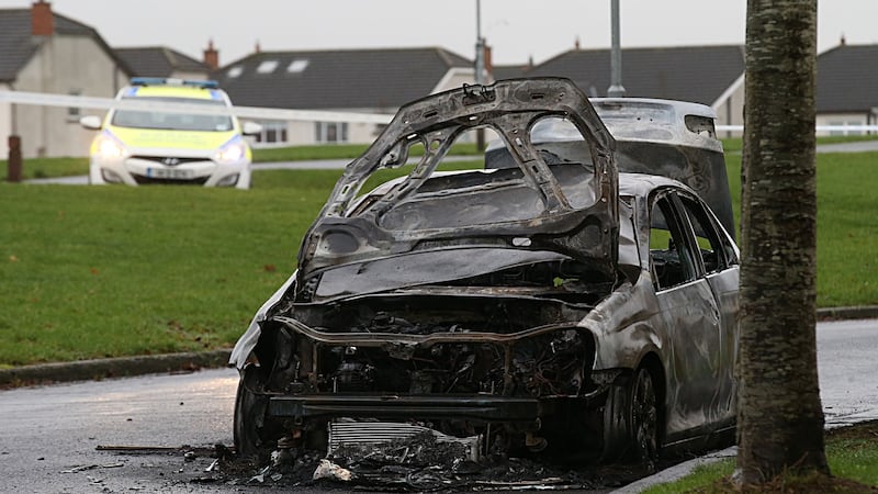 Garda preserve a burnt out Volkswagen Jetta found at Rusheeney Estate near Clonee, following the killing in west Dublin. Photograph: Stephen Collins/Collins Photos