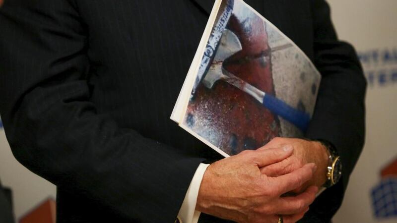 New York City Police commissioner William Bratton holds a photo of the weapon used to attack a police officer, during a news conference at Jamaica Hospital Medical Center in New York. Photograph: Kirsten Luce/The New York Times