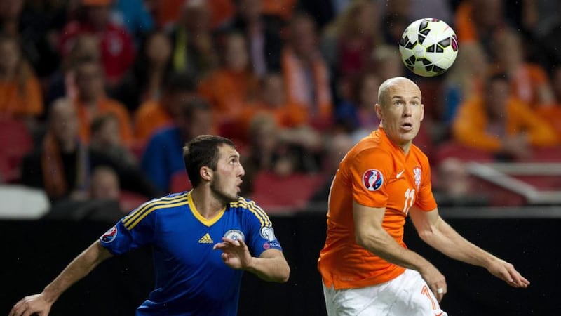 Arjen Robben gets to the ball ahead of Kazakhstan’s Gafurzhan Suyumbayev. Photograph: EPA