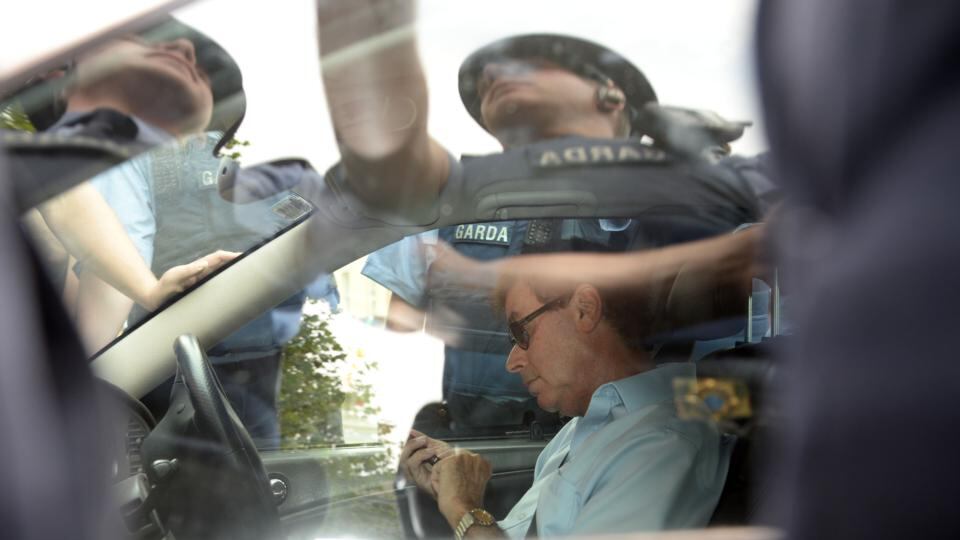 Former minister for justice Alan Shatter sits in his car outside the Dáil with gardaí outside it as protesters surrounded the vehicle on July 1st, 2015. Photograph: Dara Mac Dónaill/The Irish Times