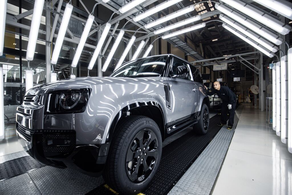 A worker performs a quality control inspection on a completed Land Rover Defender sport utility vehicle (SUV) inside a light tunnel at the Jaguar Land Rover plant. Photograph: Akos Stiller/Bloomberg