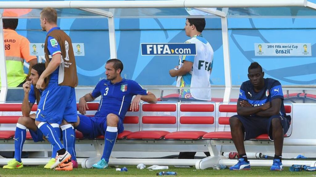 A dejected Mario Balotelli (right) looks on from the bench during the 2014 FIFA World Cup Brazil Group D match between Italy and Uruguay at Estadio das Dunas. The player has been linked with a move to Arsenal. Photograph: Claudio Villa/Getty Images