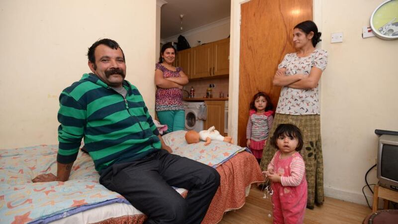 Anton Rostas in a flat with granddaughters Cristina (4), Madalina (8 months), their mother Lamaita (right) and another family member. Photograph: Alan Betson / The Irish Times