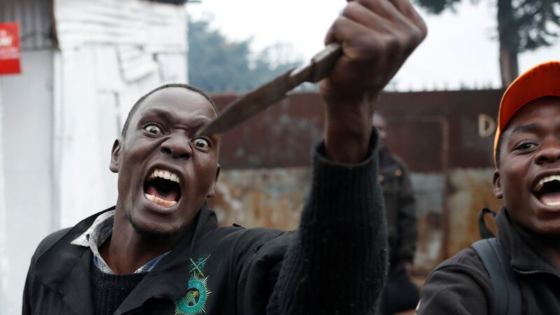 An opposition supporter gestures with a knife during clashes with police in Kibera slum in Nairobi on Thursday. Photograph: Goran Tomasevic/Reuters