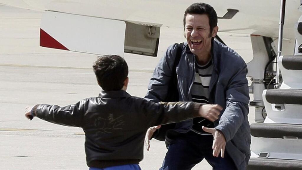 Freed El Mundo Middle East correspondent Javier Espinosa (R) laughs as his son runs towards him after his arrival at Torrejon de Ardoz airbase near Madrid today. Photograph: Paco Campos/ Pool/Reuters