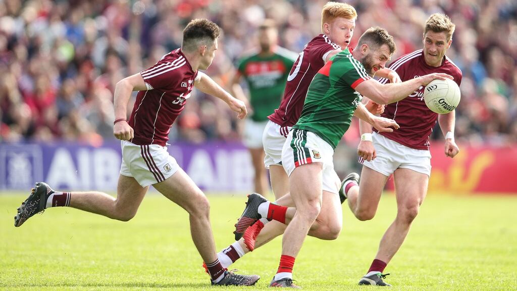 Mayo’s Seamus O’Shea under pressure from Barry McHugh, Peter Cooke, and Gary O’Donnell of Galway. Photograph: Cathal Noonan/Inpho
