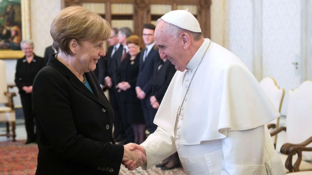 When it came to the ritual exchange, the German leader offered the Pope not only a collection Bach CDs but also a white envelope containing money, intended for child refugees from Syria and Iraq. Photograph: Osservatore Romano/AFP/Getty Images