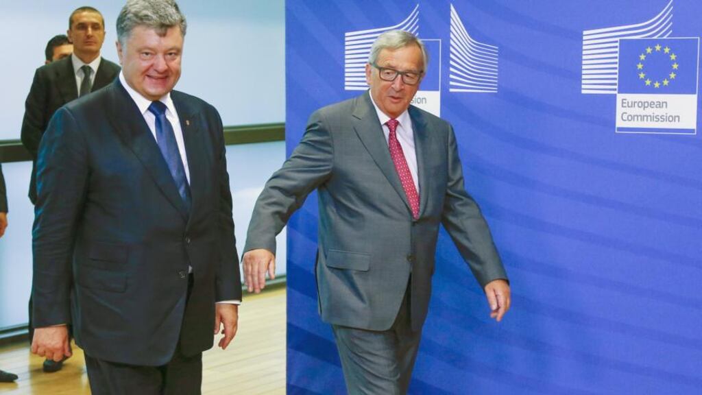 Ukraine’s President Petro Poroshenko (L) is welcomed by European Commission President Jean-Claude Juncker (R) ahead of their meeting at the EU Commission headquarters in Brussels, Belgium. Ukraine said it has agreed a restructuring deal with creditors after five months of talks (Photograph: Yves Herman/Reuters)