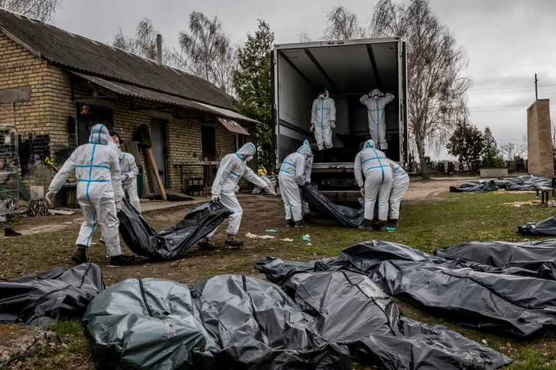 Volunteers load some 65 corpses to be taken for forensic study in Bucha, Ukraine in April. “We found the same rape and torture chambers in Izium and other cities of the Kharkiv region,” Matviichuk says. Photograph: Daniel Berehulak/New York Times