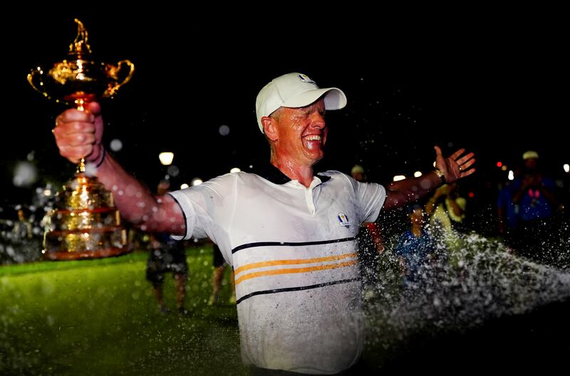 Europe captain Luke Donald is showered with champagne as he holds the Ryder Cup. Photograph: David Davies/PA